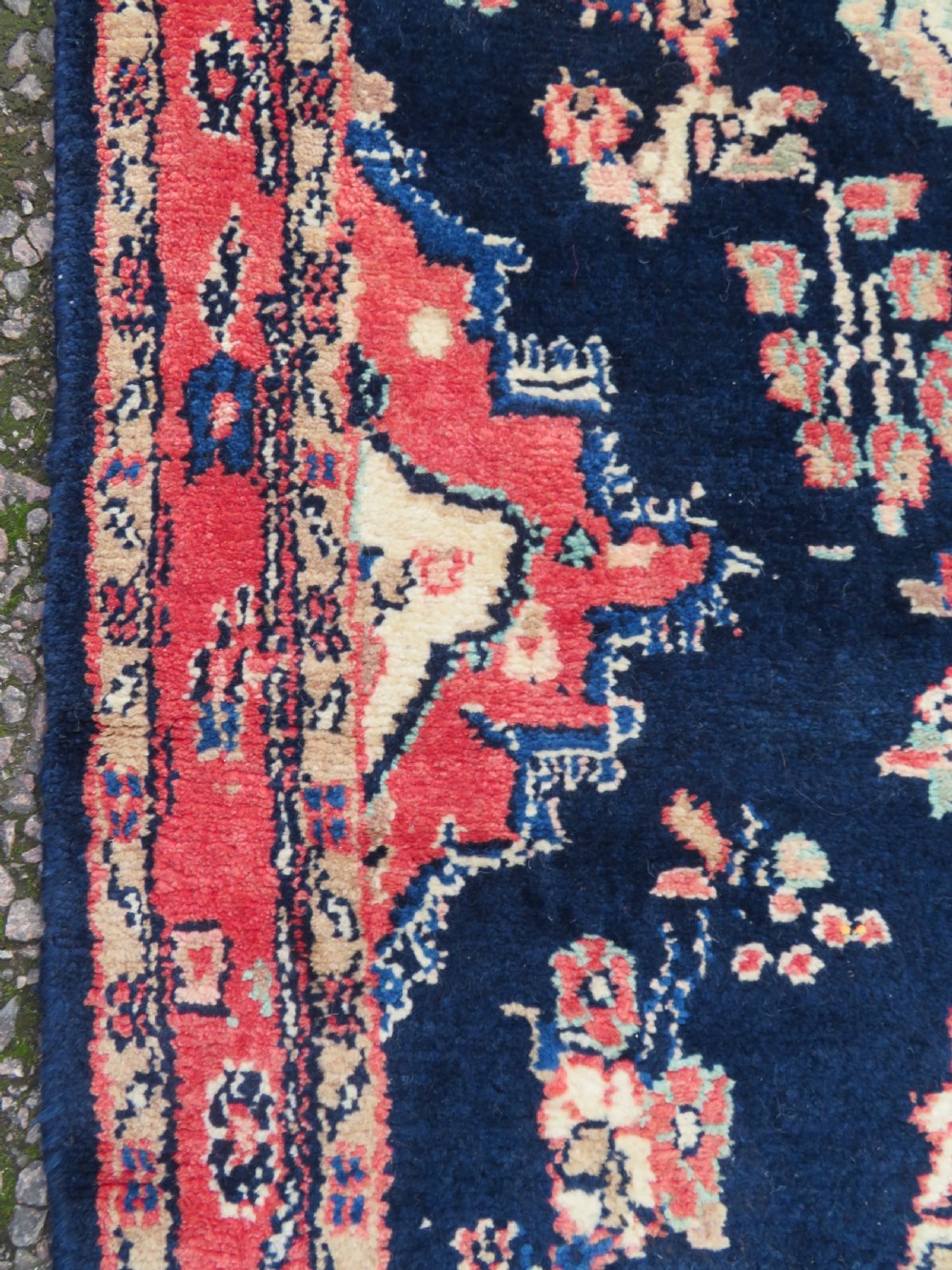 A long, narrow hand-knotted Persian Sarouk runner rug featuring a deep navy blue field, central floral medallions, and terracotta borders. View V