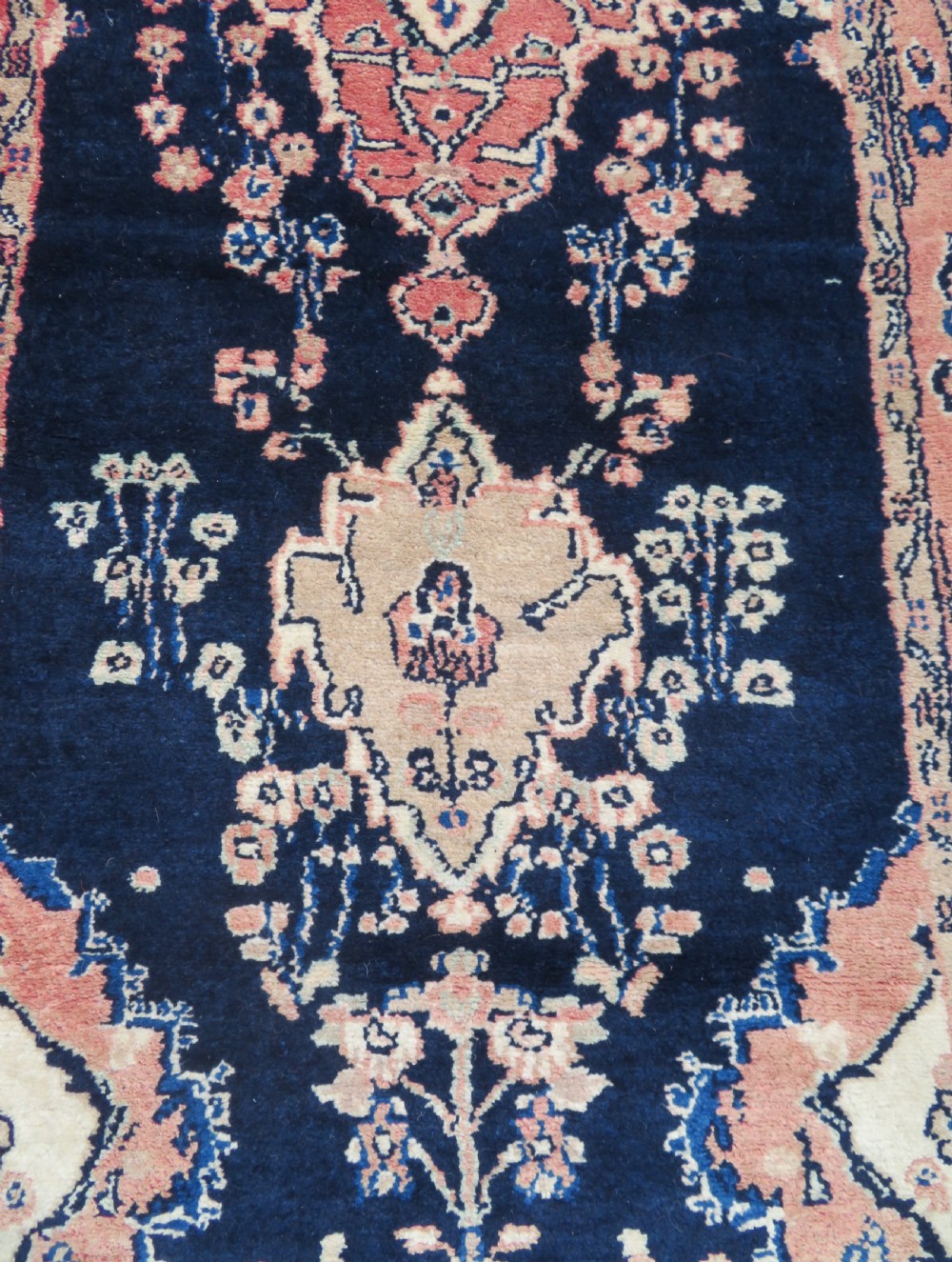A long, narrow hand-knotted Persian Sarouk runner rug featuring a deep navy blue field, central floral medallions, and terracotta borders. View VII