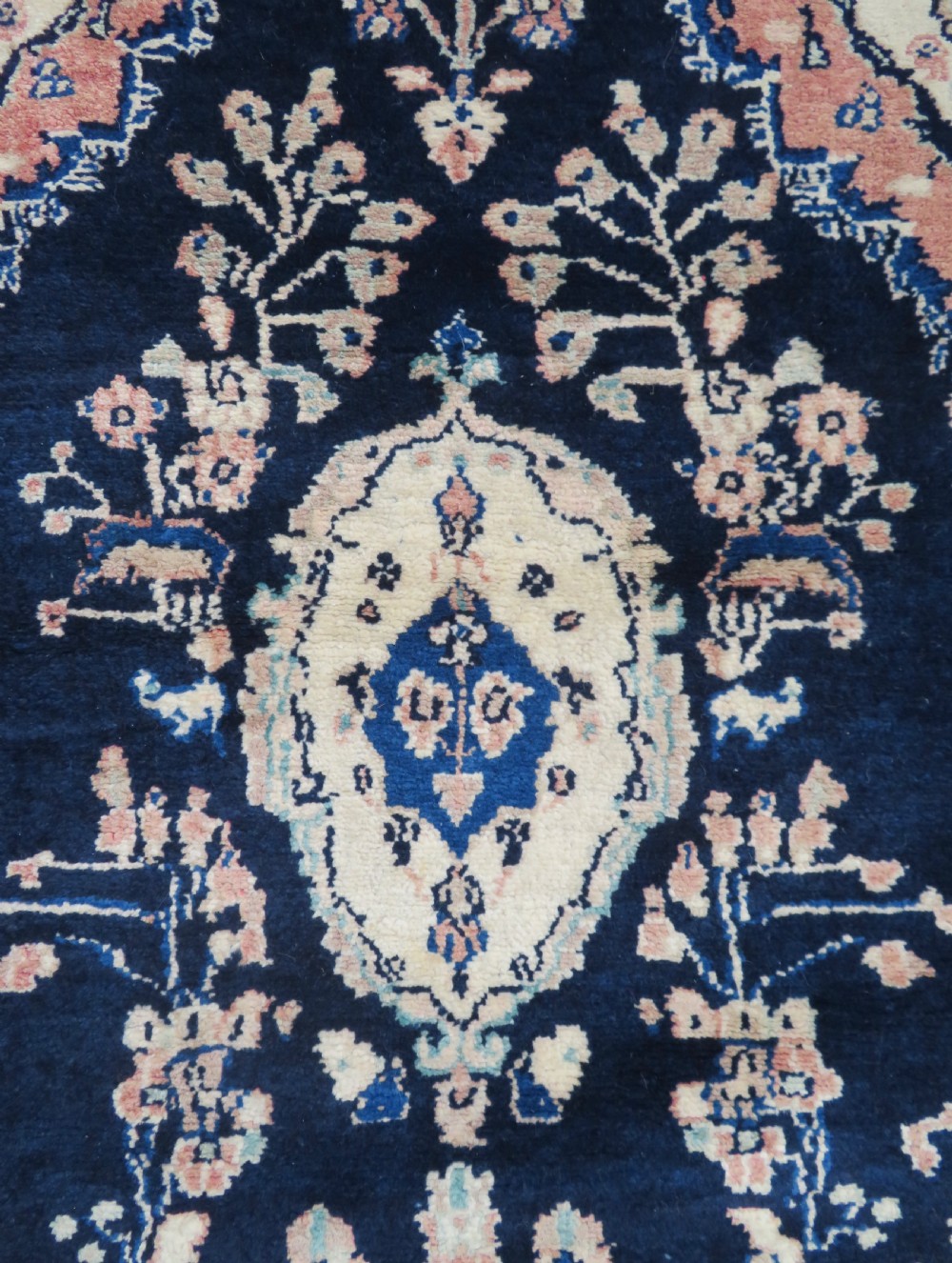 A long, narrow hand-knotted Persian Sarouk runner rug featuring a deep navy blue field, central floral medallions, and terracotta borders. View VIII