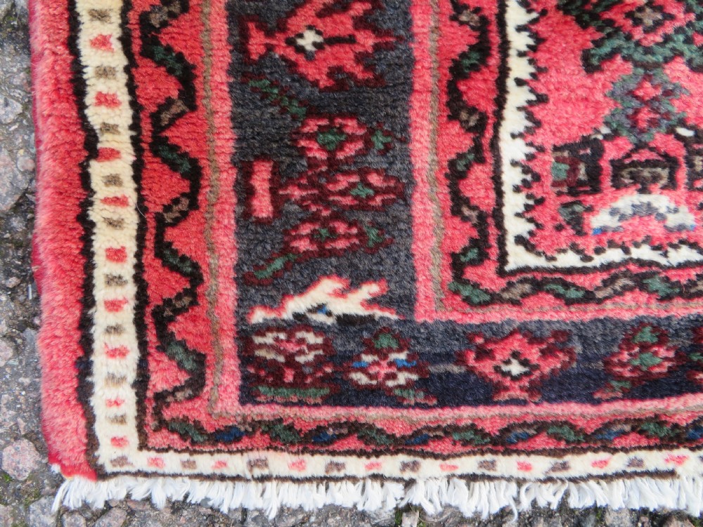A long, narrow hand-knotted Persian Hamadan runner rug featuring a red field woven with geometric motifs and dark patterned borders. View VIII