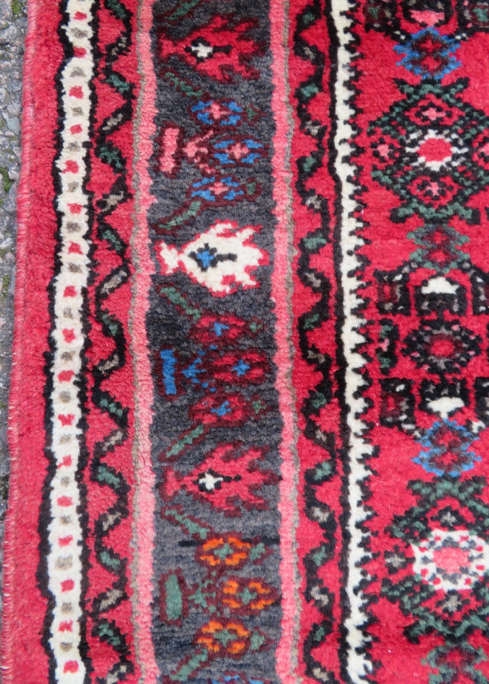 A long, narrow hand-knotted Persian Hamadan runner rug featuring a red field woven with geometric motifs and dark patterned borders. View XI