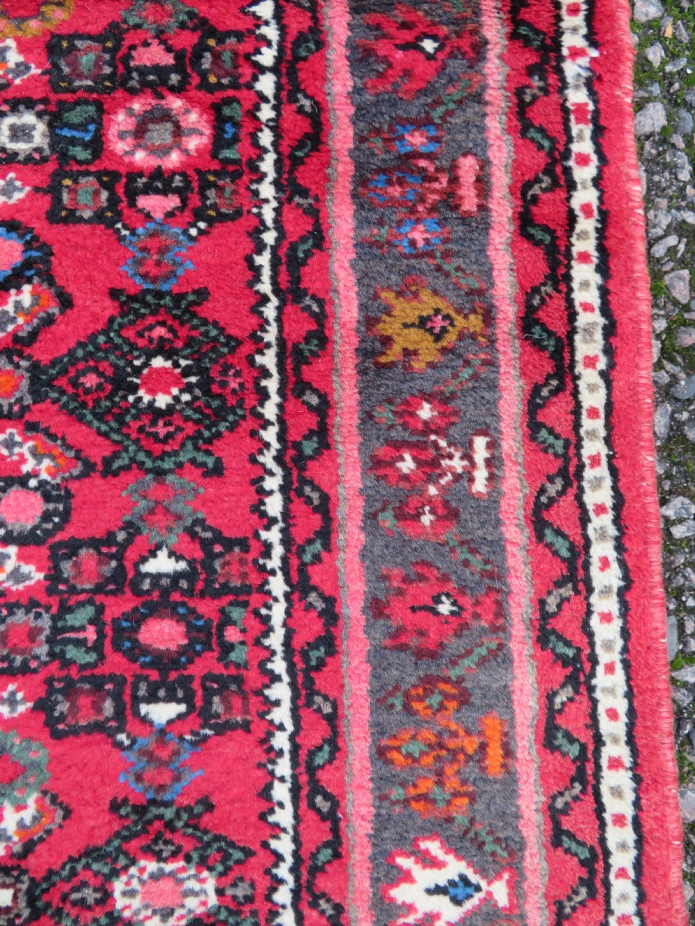 A long, narrow hand-knotted Persian Hamadan runner rug featuring a red field woven with geometric motifs and dark patterned borders. View XII