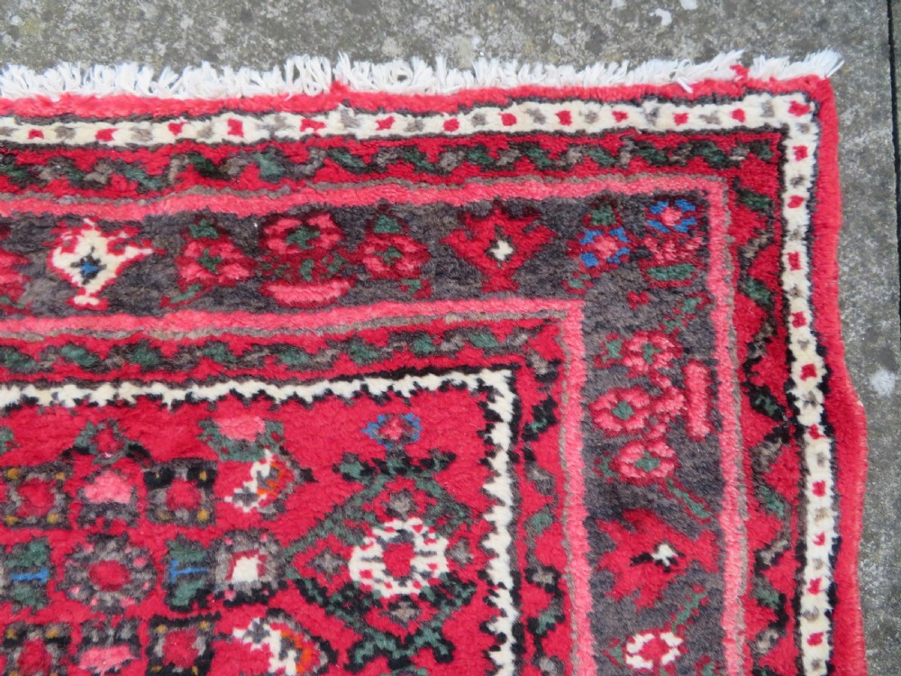 A long, narrow hand-knotted Persian Hamadan runner rug featuring a red field woven with geometric motifs and dark patterned borders. View XV
