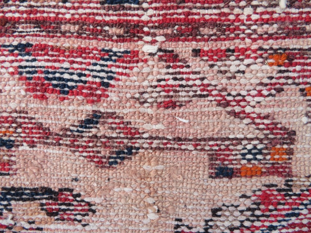 An antique Persian Malayer hand-knotted wool rug featuring a red central field, stepped navy medallion, ivory spandrels, and geometric floral borders. View XVII