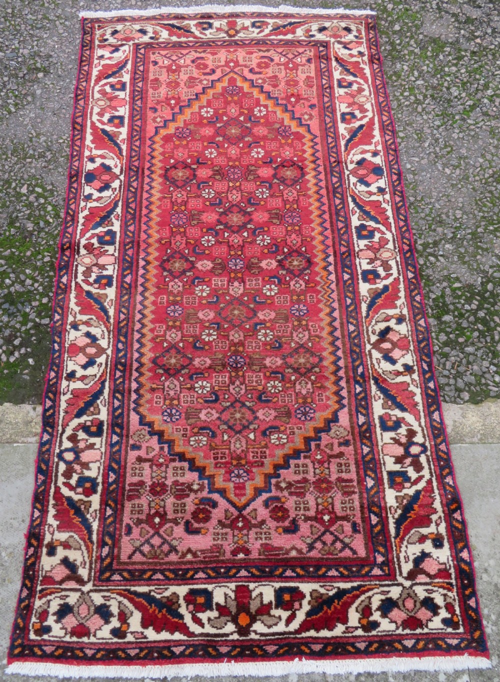 An antique Persian Sanjan Hamadan wool rug runner featuring a central diamond medallion surrounded by geometric motifs in red, cream, and navy blue. View II