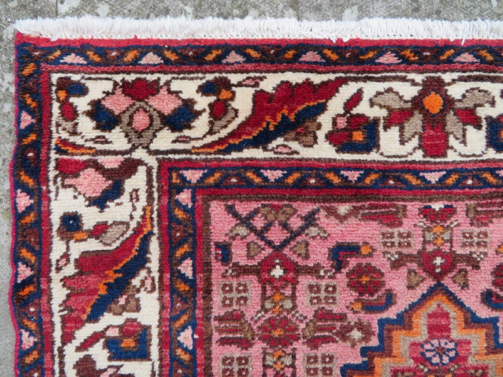 An antique Persian Sanjan Hamadan wool rug runner featuring a central diamond medallion surrounded by geometric motifs in red, cream, and navy blue. View VIII