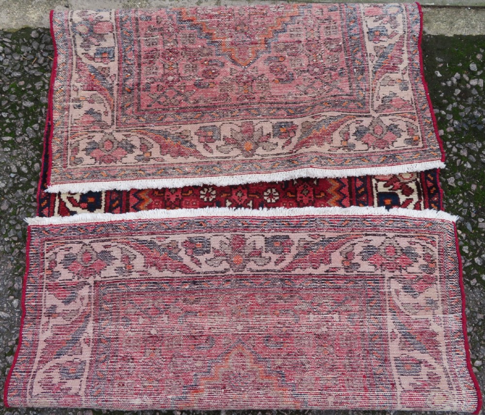 An antique Persian Sanjan Hamadan wool rug runner featuring a central diamond medallion surrounded by geometric motifs in red, cream, and navy blue. View XII