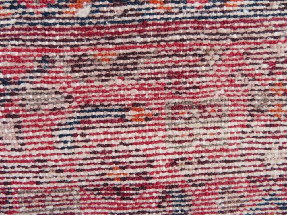 An antique Persian Sanjan Hamadan wool rug runner featuring a central diamond medallion surrounded by geometric motifs in red, cream, and navy blue. View XIV