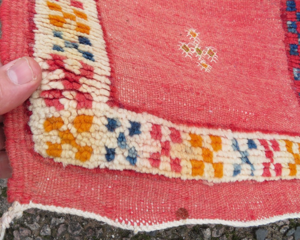 An extra long and narrow handwoven Moroccan Berber runner rug featuring geometric panels in pink, light blue, yellow, and navy with fringed ends. View XI