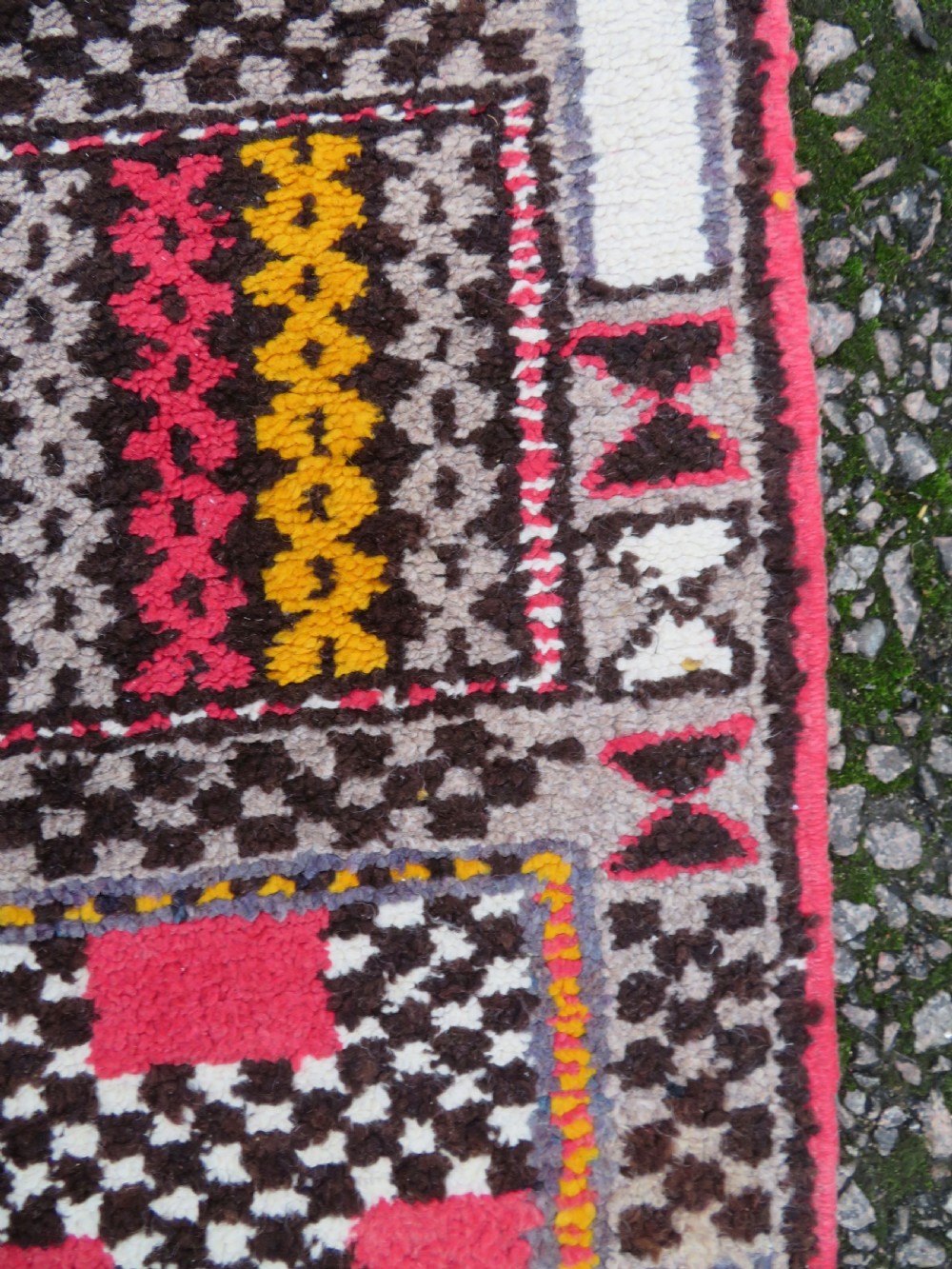 A rectangular hand-knotted Moroccan Berber wool rug featuring geometric patchwork panels in pink, yellow, black, grey, and white with fringed ends. View VIII