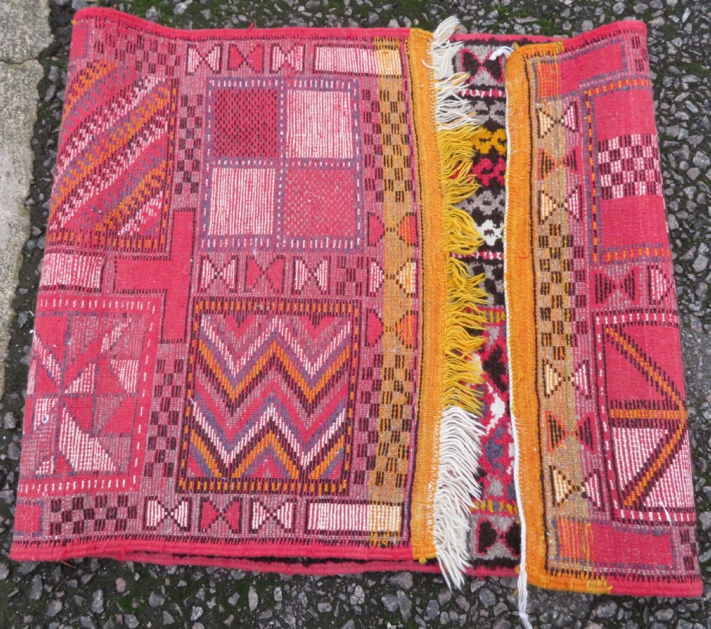 A rectangular hand-knotted Moroccan Berber wool rug featuring geometric patchwork panels in pink, yellow, black, grey, and white with fringed ends. View XI