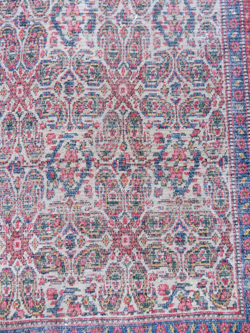A nineteenth-century Persian Fereghan wool rug featuring an intricate all-over floral lattice pattern framed by navy and terracotta borders. View VII