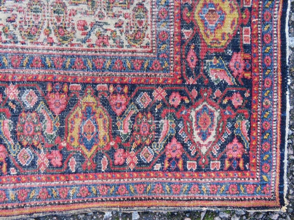 A nineteenth-century Persian Fereghan wool rug featuring an intricate all-over floral lattice pattern framed by navy and terracotta borders. View VIII