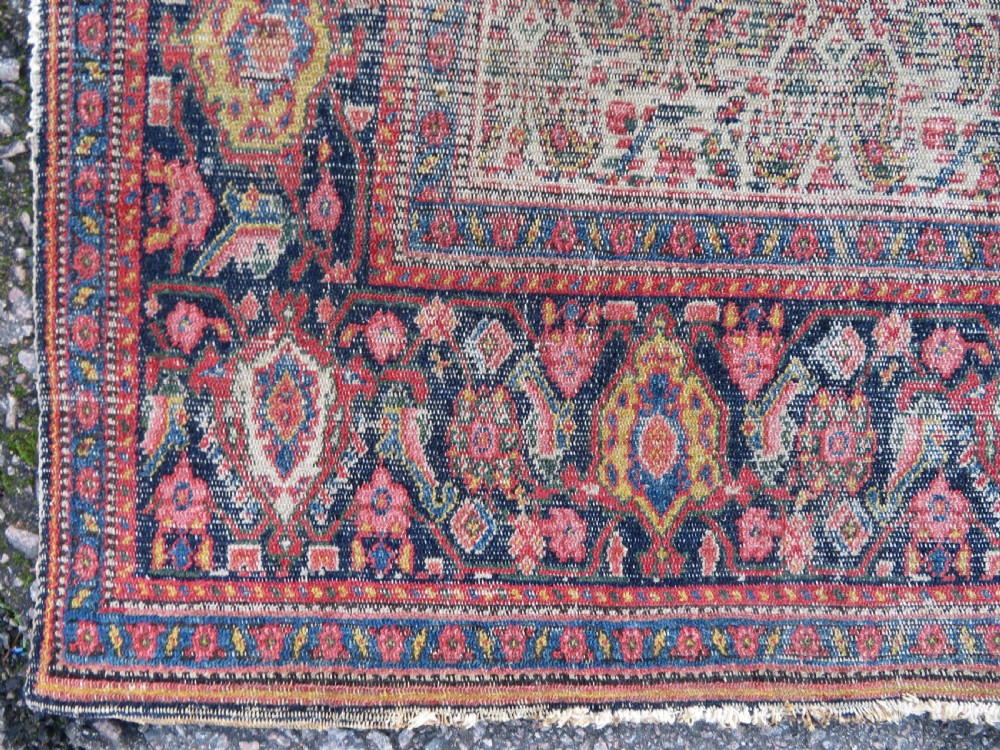 A nineteenth-century Persian Fereghan wool rug featuring an intricate all-over floral lattice pattern framed by navy and terracotta borders. View IX