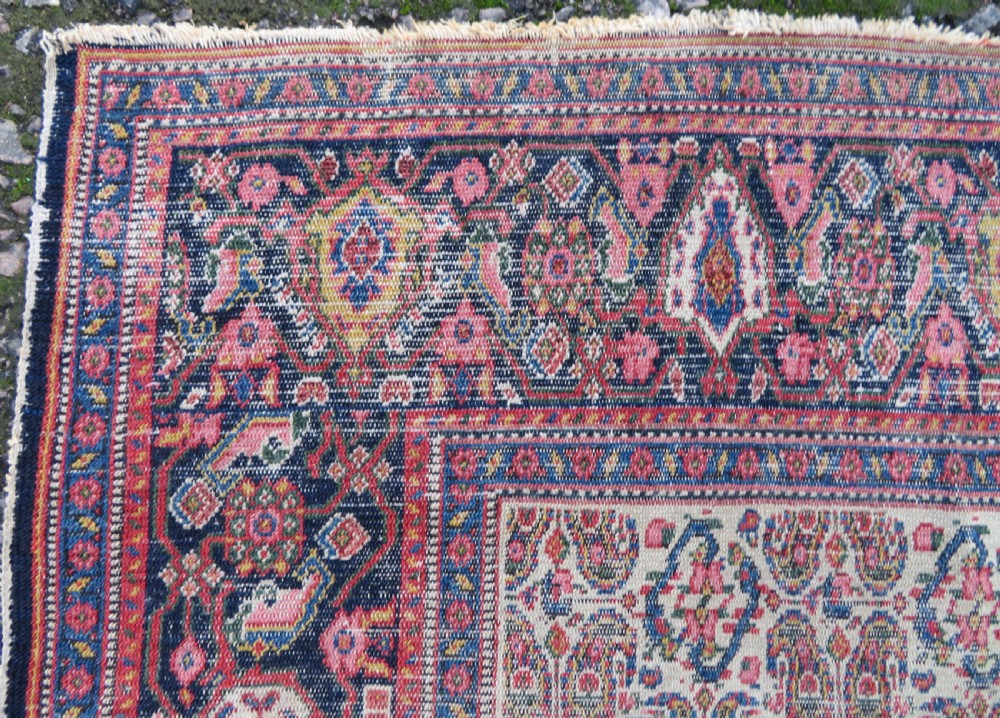 A nineteenth-century Persian Fereghan wool rug featuring an intricate all-over floral lattice pattern framed by navy and terracotta borders. View X