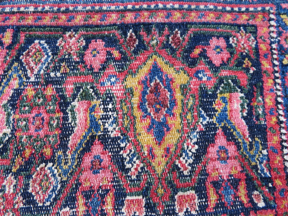 A nineteenth-century Persian Fereghan wool rug featuring an intricate all-over floral lattice pattern framed by navy and terracotta borders. View XII