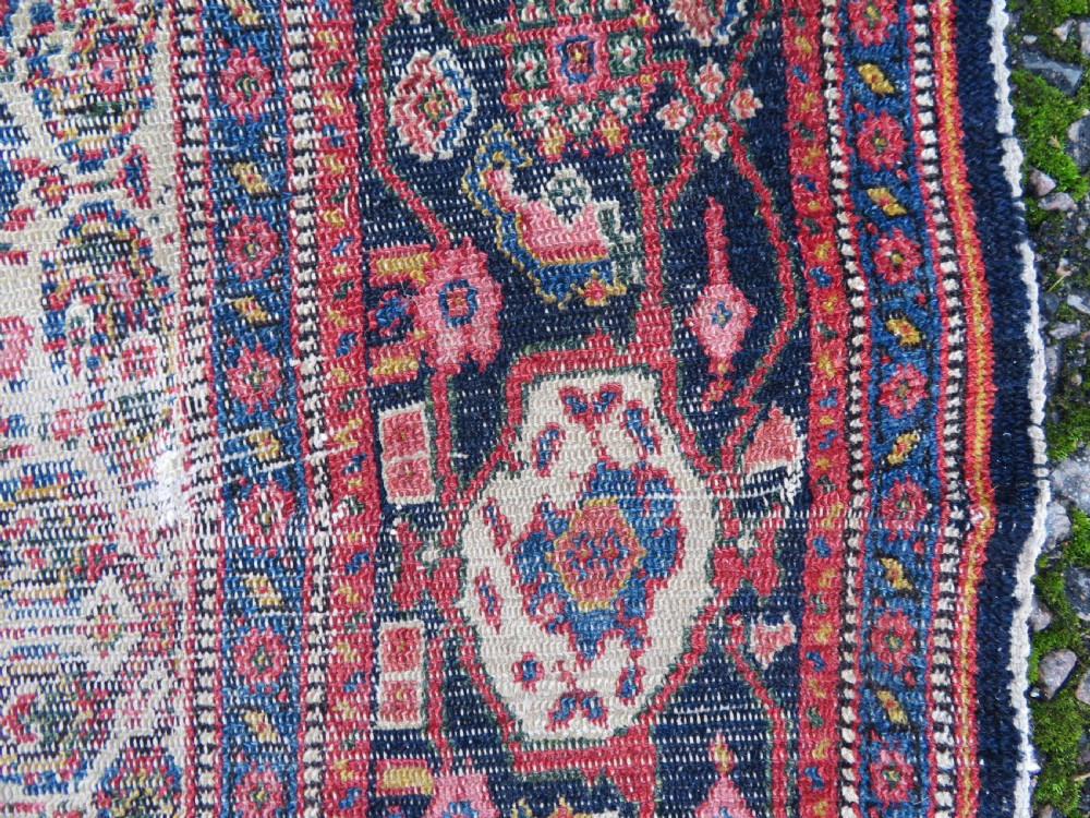 A nineteenth-century Persian Fereghan wool rug featuring an intricate all-over floral lattice pattern framed by navy and terracotta borders. View XIII