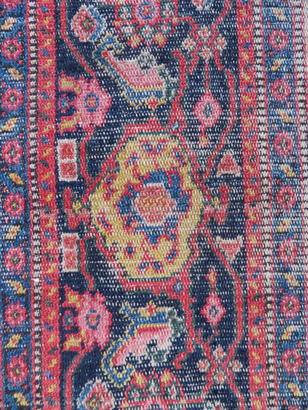 A nineteenth-century Persian Fereghan wool rug featuring an intricate all-over floral lattice pattern framed by navy and terracotta borders. View XV