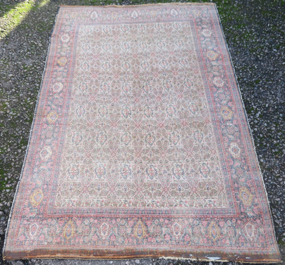 A nineteenth-century Persian Fereghan wool rug featuring an intricate all-over floral lattice pattern framed by navy and terracotta borders. View XVI