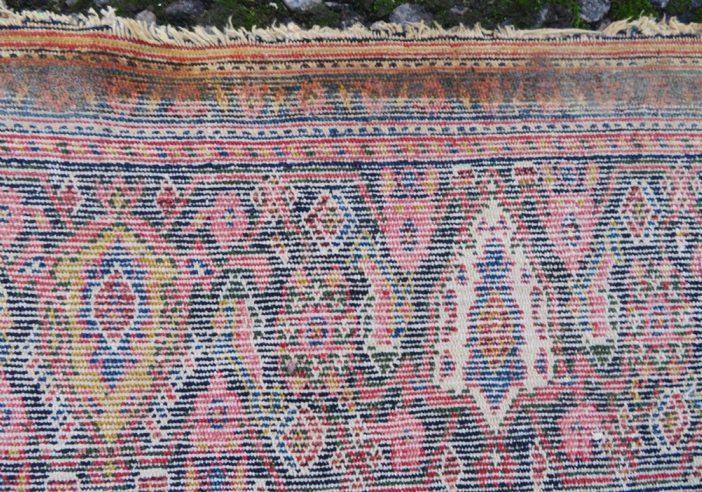 A nineteenth-century Persian Fereghan wool rug featuring an intricate all-over floral lattice pattern framed by navy and terracotta borders. View XVIII