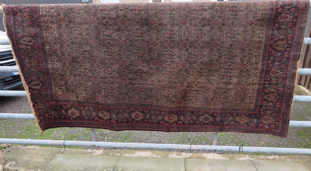 A nineteenth-century Persian Fereghan wool rug featuring an intricate all-over floral lattice pattern framed by navy and terracotta borders. View XXV