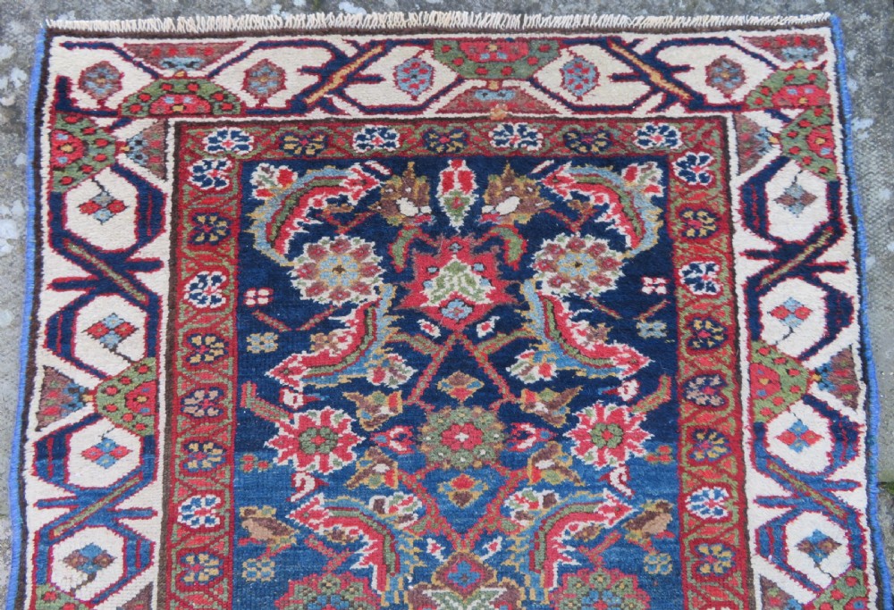 A long, narrow antique Persian Fereghan runner rug featuring detailed floral lattice motifs on a deep navy field framed by multi-tiered terracotta red and cream patterned borders. View III