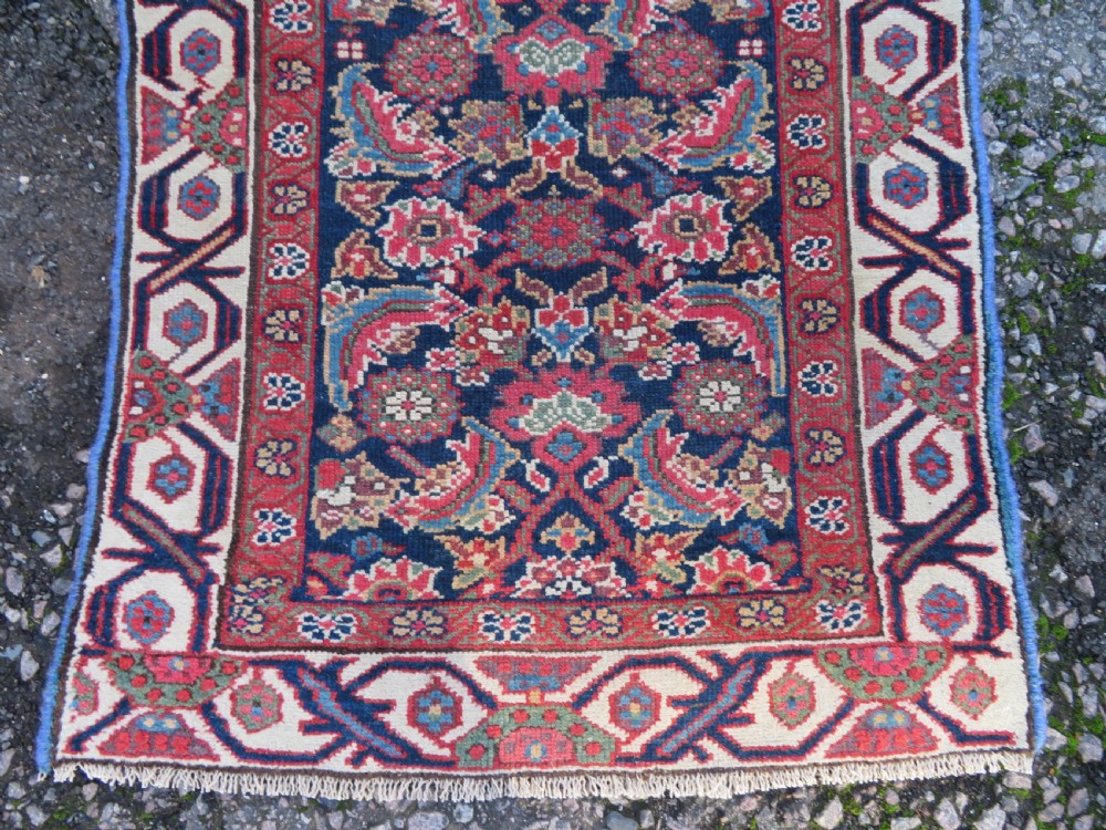 A long, narrow antique Persian Fereghan runner rug featuring detailed floral lattice motifs on a deep navy field framed by multi-tiered terracotta red and cream patterned borders. View VIII