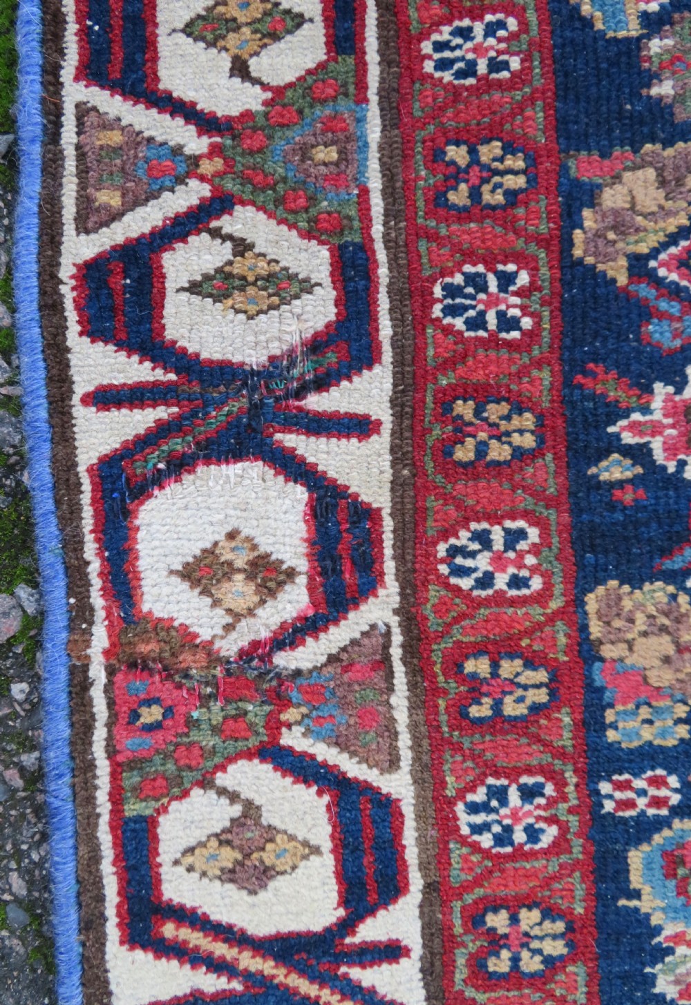 A long, narrow antique Persian Fereghan runner rug featuring detailed floral lattice motifs on a deep navy field framed by multi-tiered terracotta red and cream patterned borders. View IX