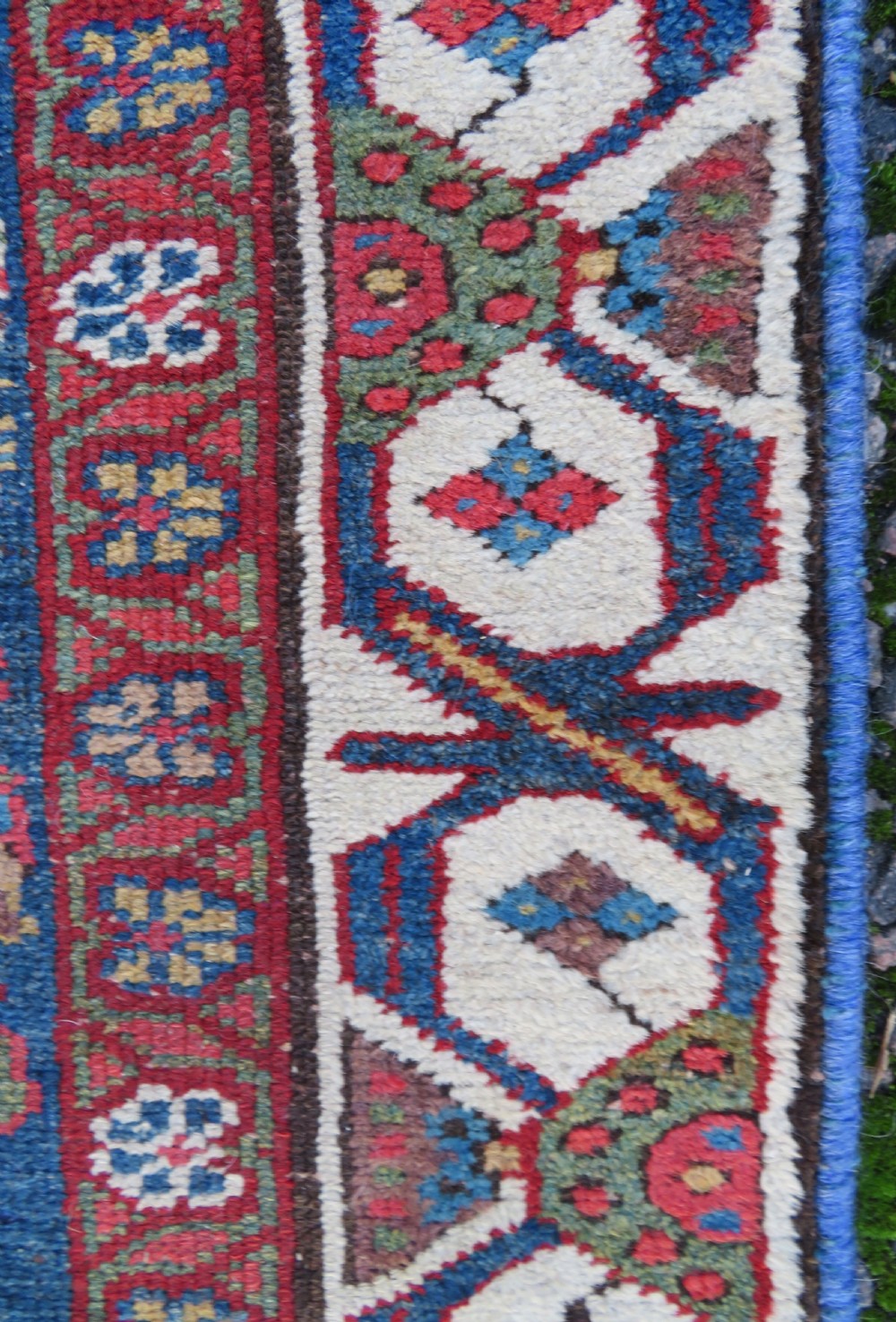 A long, narrow antique Persian Fereghan runner rug featuring detailed floral lattice motifs on a deep navy field framed by multi-tiered terracotta red and cream patterned borders. View XI