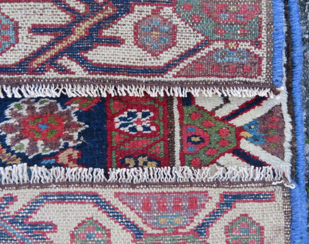 A long, narrow antique Persian Fereghan runner rug featuring detailed floral lattice motifs on a deep navy field framed by multi-tiered terracotta red and cream patterned borders. View XIV