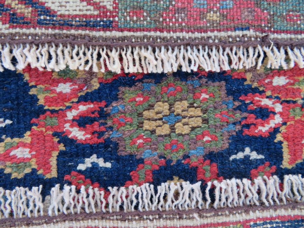 A long, narrow antique Persian Fereghan runner rug featuring detailed floral lattice motifs on a deep navy field framed by multi-tiered terracotta red and cream patterned borders. View XVI