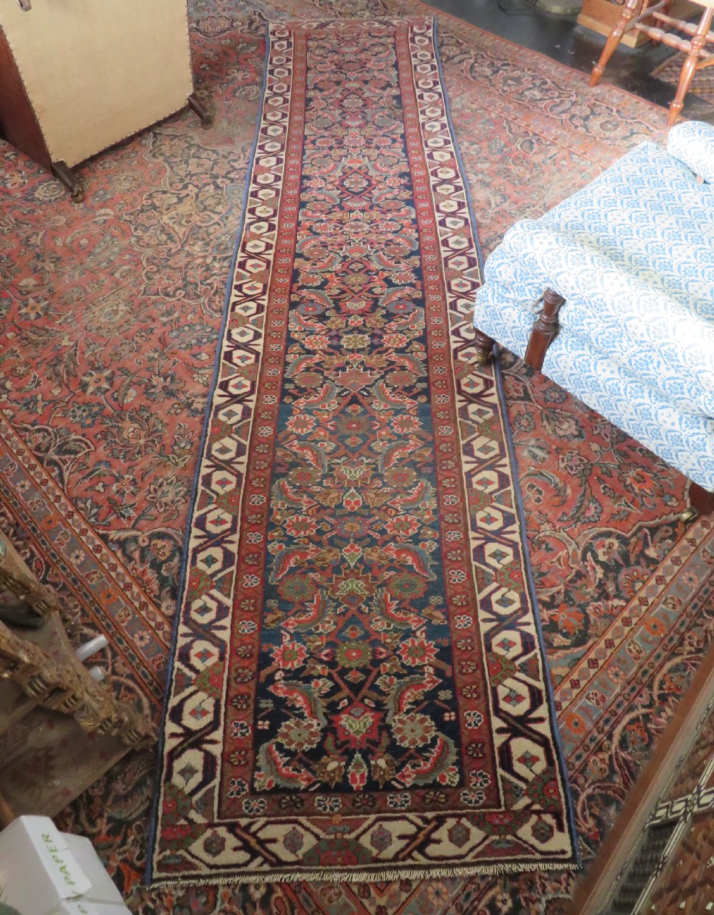A long, narrow antique Persian Fereghan runner rug featuring detailed floral lattice motifs on a deep navy field framed by multi-tiered terracotta red and cream patterned borders. View XVIII