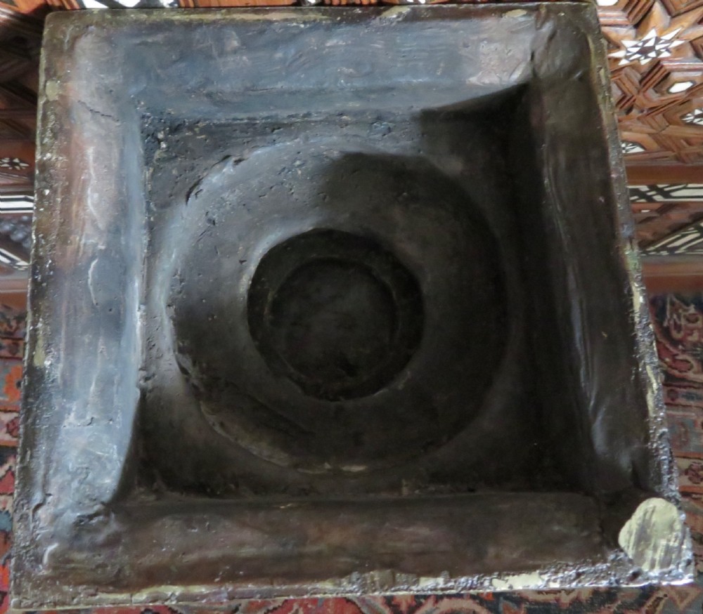 A four-armed dark bronze figure of the Hindu deity Shiva standing atop a stylized lotus base and rectangular pedestal. View VII