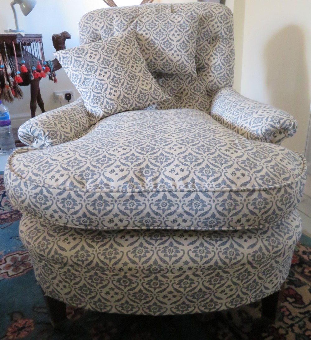 A deep upholstered easy armchair featuring blue and cream patterned fabric with button-back detailing and matching loose cushions. View II
