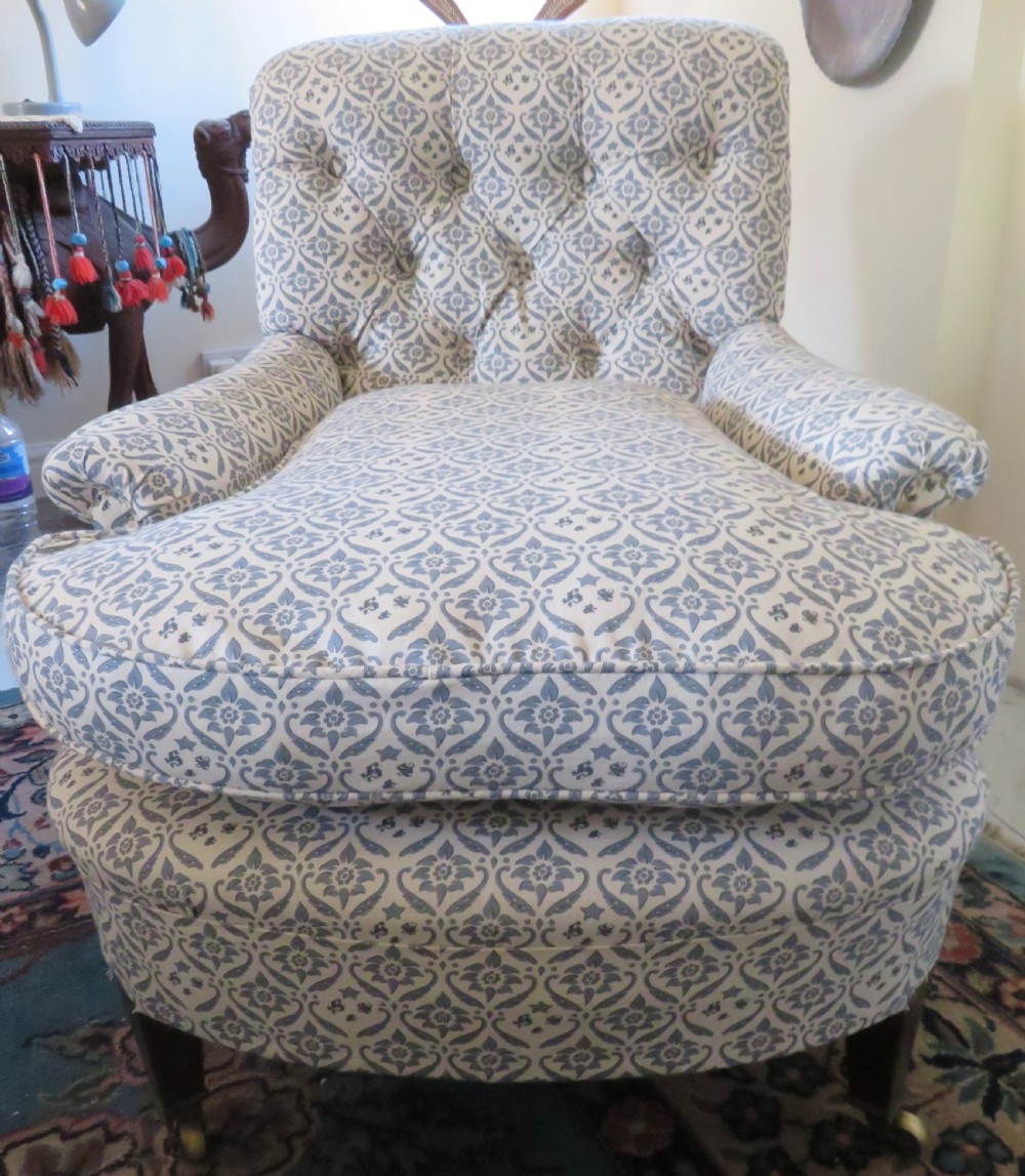 A deep upholstered easy armchair featuring blue and cream patterned fabric with button-back detailing and matching loose cushions. View IV