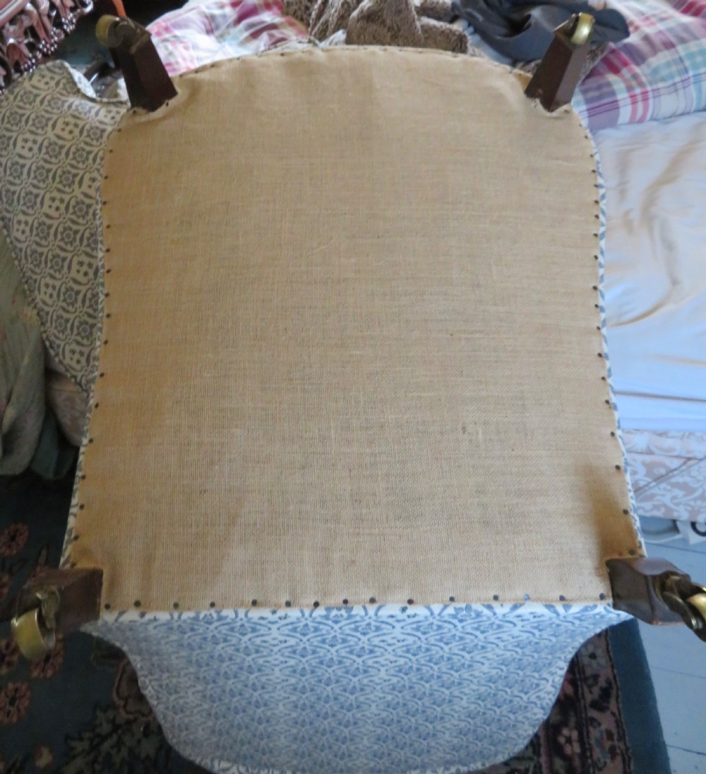 A deep upholstered easy armchair featuring blue and cream patterned fabric with button-back detailing and matching loose cushions. View XI