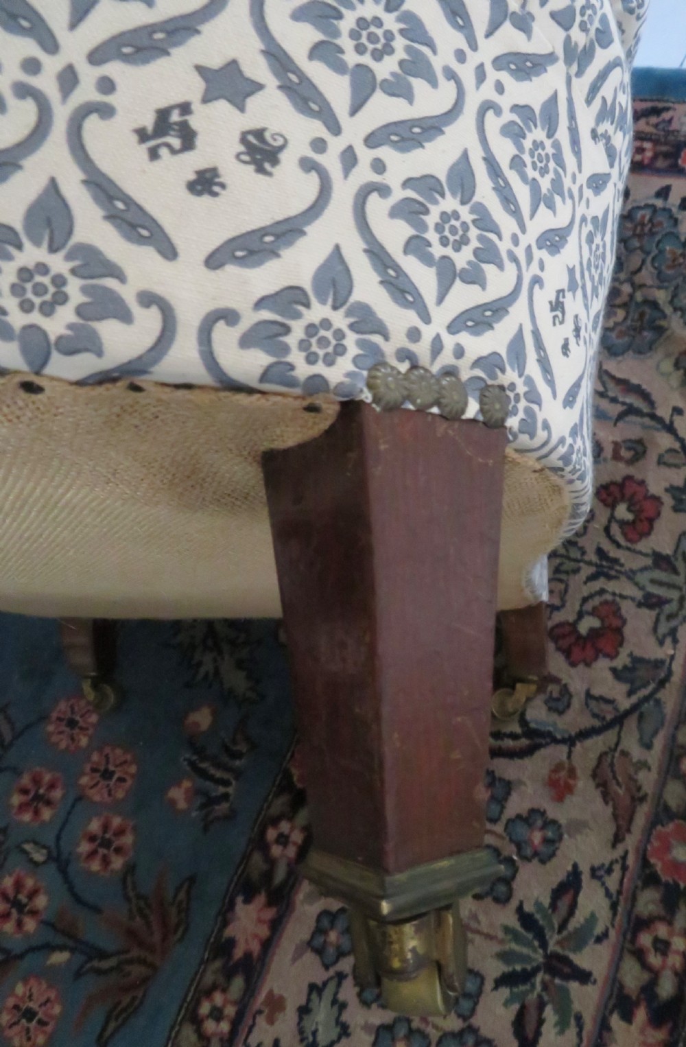 A deep upholstered easy armchair featuring blue and cream patterned fabric with button-back detailing and matching loose cushions. View XXII