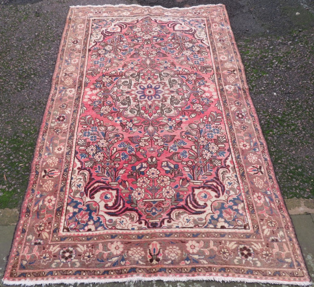 A large rectangular hand-knotted Persian Hamadan wool rug featuring a central floral medallion surrounded by intricate floral motifs in shades of rose pink, cream, brown, and blue. View II