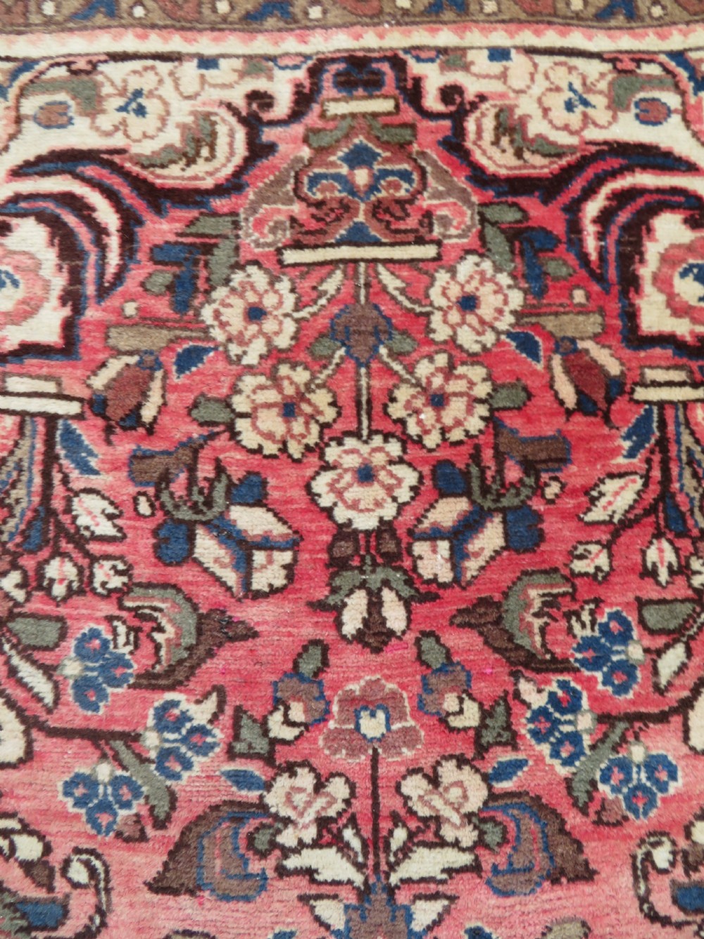A large rectangular hand-knotted Persian Hamadan wool rug featuring a central floral medallion surrounded by intricate floral motifs in shades of rose pink, cream, brown, and blue. View V