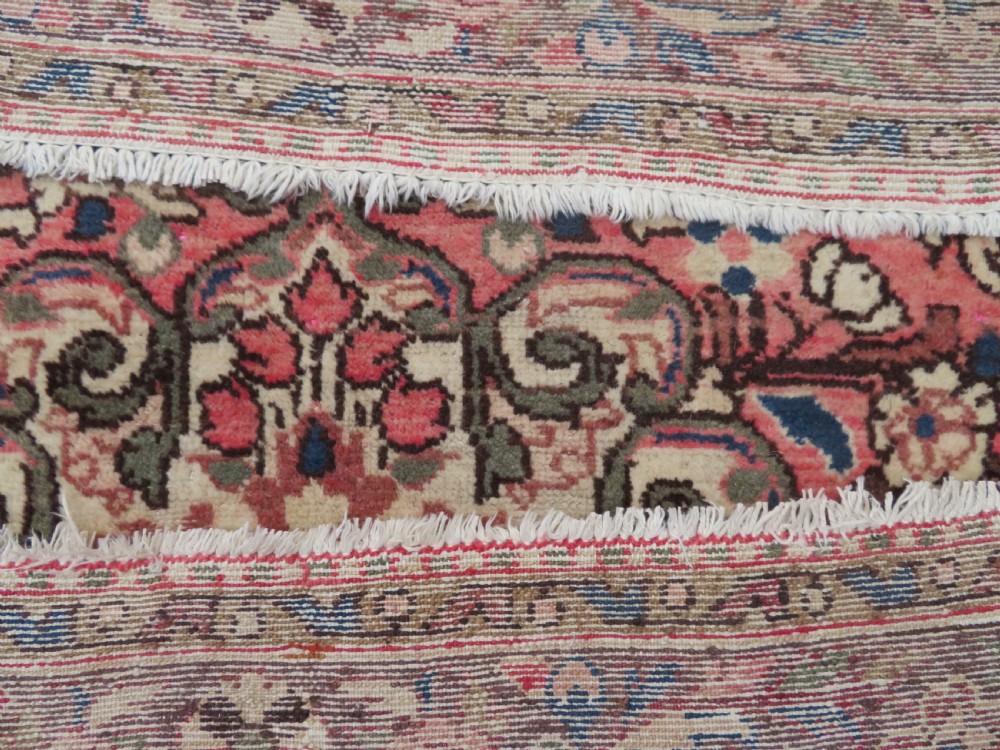 A large rectangular hand-knotted Persian Hamadan wool rug featuring a central floral medallion surrounded by intricate floral motifs in shades of rose pink, cream, brown, and blue. View XV
