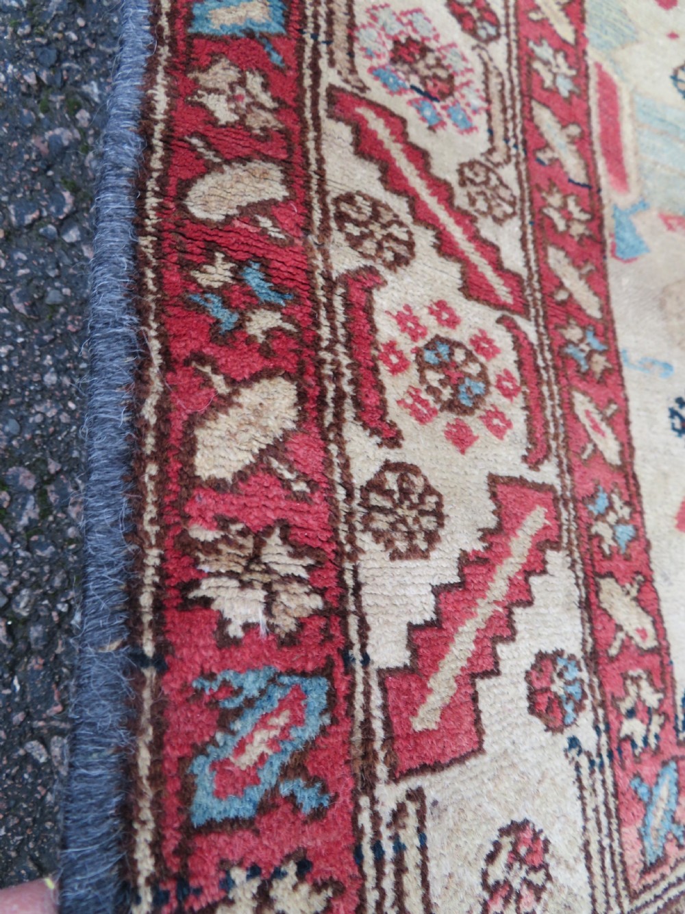 An antique Bakshaish hand-knotted wool rug featuring a navy blue and terracotta central geometric medallion on a cream field with patterned borders. View IX