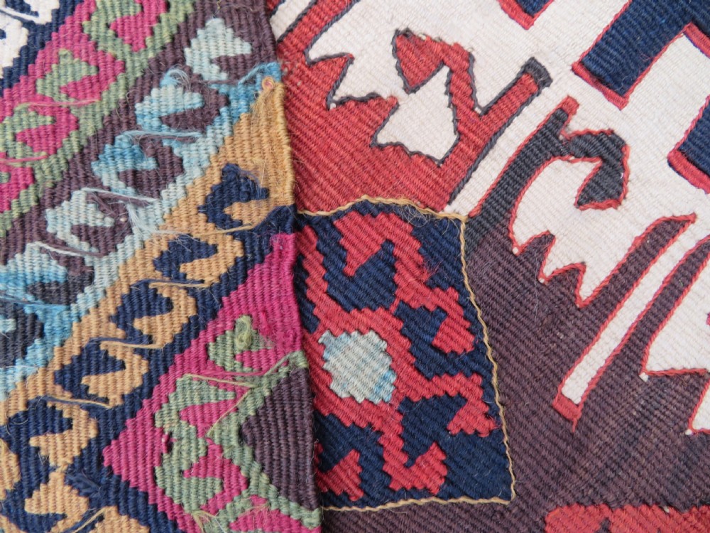 A long handwoven Turkish flatweave Kilim runner featuring intricate geometric diamond medallions in red, navy blue, green, and cream. View XI