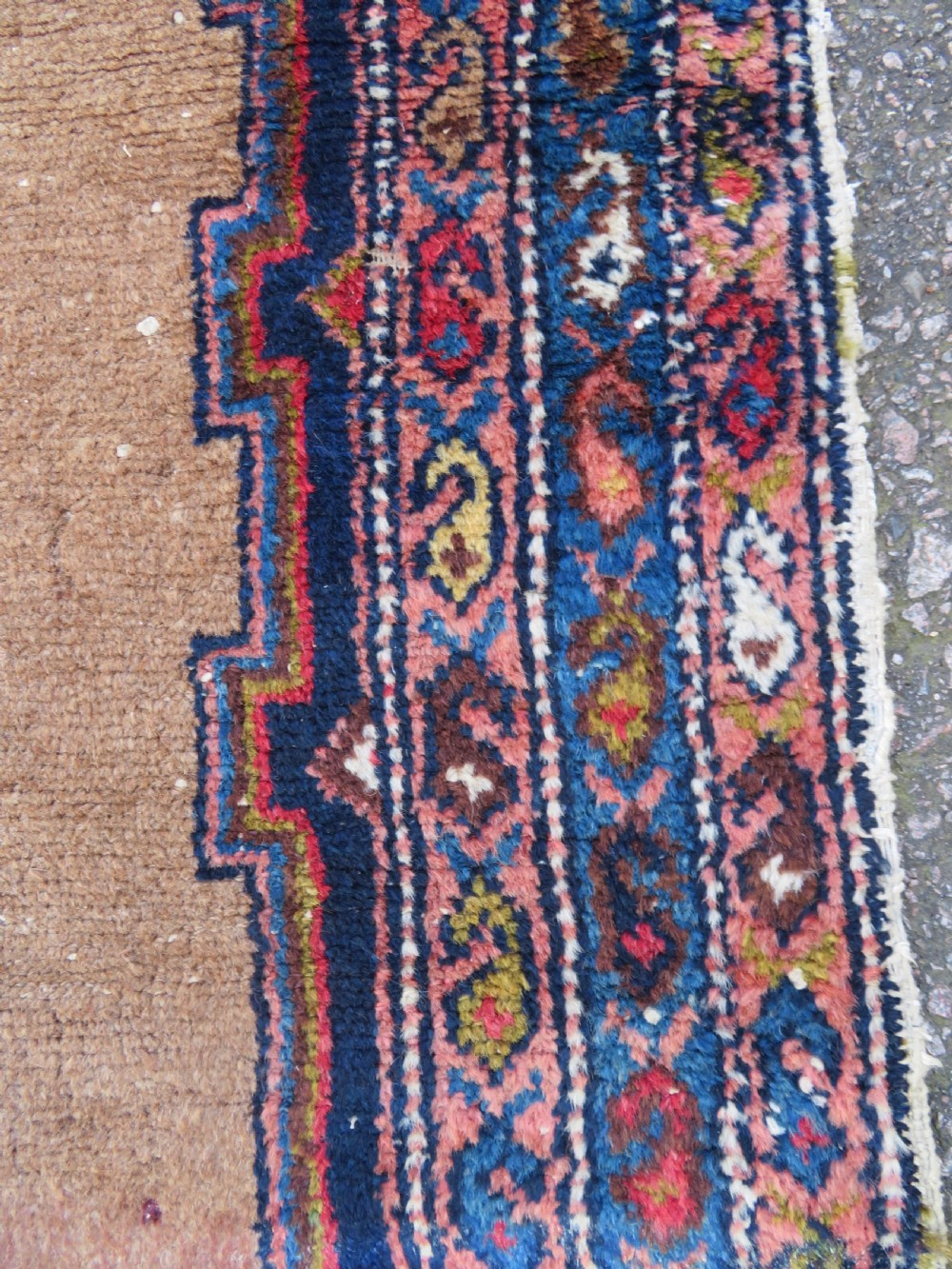 An antique hand-knotted Persian Hamadan wool rug featuring a geometric central medallion on a camel field with navy and red accents. View X