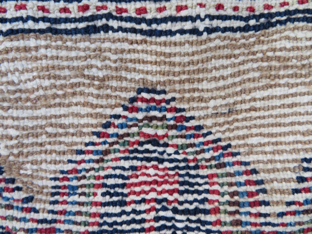 An antique hand-knotted Persian Hamadan wool rug featuring a geometric central medallion on a camel field with navy and red accents. View XIII