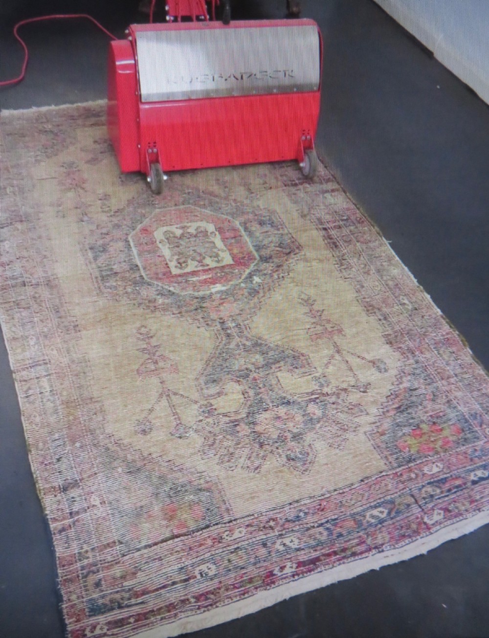 An antique hand-knotted Persian Hamadan wool rug featuring a geometric central medallion on a camel field with navy and red accents. View XVI
