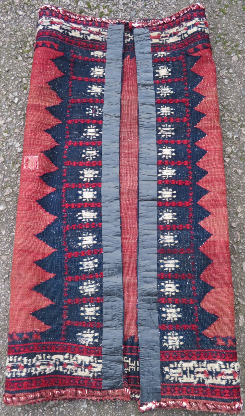 A square antique Afshar flatweave sofreh rug with a faded red central field and serrated indigo blue geometric borders. View IX