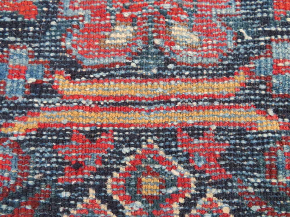 A rectangular hand-knotted antique Afshar rug featuring geometric floral motifs in terracotta red and sky blue on a deep navy blue background. View XIV