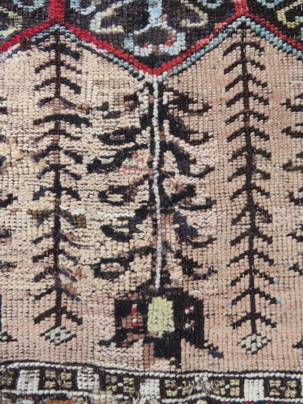 An antique hand-knotted Turkish Ladik wool prayer rug featuring a central pale blue mihrab niche, inverted tulip motifs, and multi-coloured geometric borders. View IX