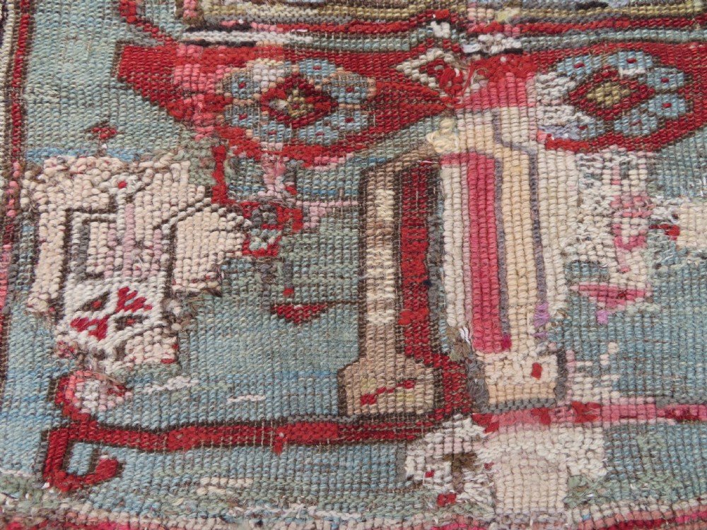 An antique hand-knotted Turkish Ladik wool prayer rug featuring a central pale blue mihrab niche, inverted tulip motifs, and multi-coloured geometric borders. View X