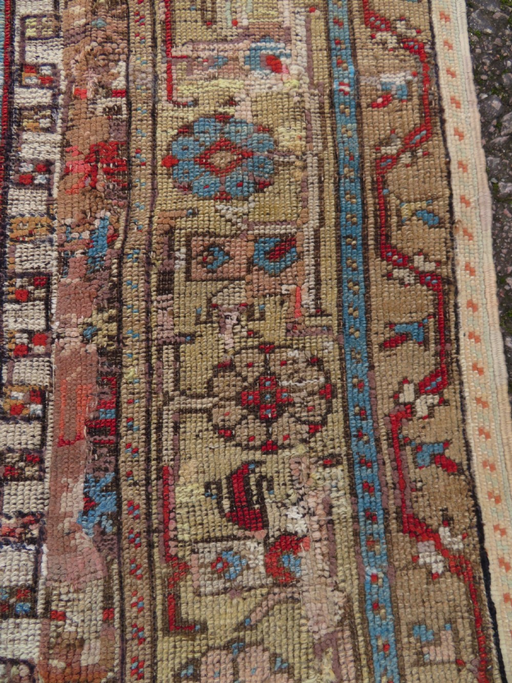 An antique hand-knotted Turkish Ladik wool prayer rug featuring a central pale blue mihrab niche, inverted tulip motifs, and multi-coloured geometric borders. View XIV